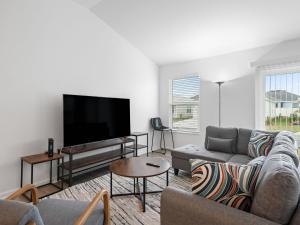 a living room with a couch and a flat screen tv at 1642 Z5 VILLAGE OF LAKE DENHAM by REMAX Premier in Leesburg