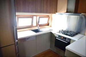 a small kitchen with a sink and a stove at Panoramic deluxe penthouse in Thérissos