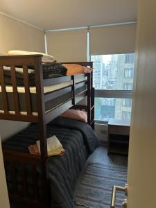 a room with a bunk bed and a window at Departamento Santiago Centro Factura Empresas in Santiago