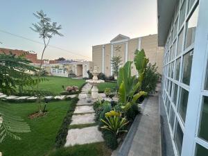 a backyard with a garden and a building at ASNB Farm House 2BHK with Pool in Multan