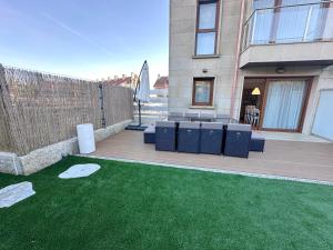 a backyard with a patio with a green lawn at Adosado O Recuncho de Arra in Vista Alegre