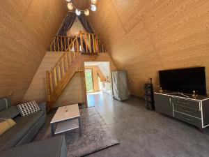a living room with a couch and a tv at Suntau in Almaty +23 photos