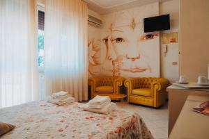 Postel nebo postele na pokoji v ubytování Hotel Julia