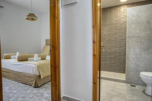 a bedroom with a bed and a bathroom with a shower at Maison Ciel in Agia Paraskevi +77 photos
