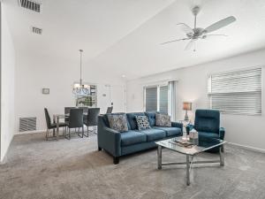 a living room with a blue couch and a table at 2142 Z6 VILLAGE OF MCCLURE by REMAX Premier in The Villages