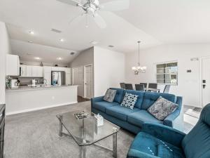 a living room with a blue couch and a table at 2142 Z6 VILLAGE OF MCCLURE by REMAX Premier in The Villages