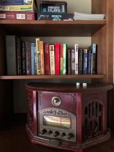 a book shelf with a wood stove and books at Trailhead Room - Near Mendenhall Glacier, Trails, and Conveniences - DISCOUNTS ON TOURS! in Mendenhaven
