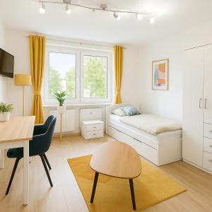 a bedroom with a bed and a desk and a table at Ressel Mansion in Bitterfeld