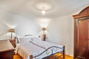 a bedroom with a bed and a wooden cabinet at Apartma Hiša Pliska in Pliskovica