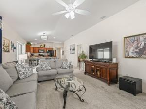 a living room with a couch and a flat screen tv at 2455 Z6 Village of Desoto by REMAX Premier in The Villages