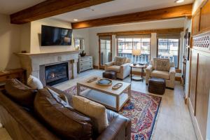 a living room with a couch and a fireplace at The Chateaux Deer Valley in Park City