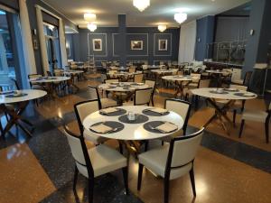 a dining room with tables and chairs in it at Grand Hotel Moroni in Finale Ligure