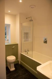 a bathroom with a toilet and a tub and a sink at Luxury 2 Bed Woodland Cottage on Rewilding Estate in Beaminster +41 photos