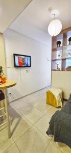 a living room with a tv on the wall at Rent for Days in San Miguel de Tucumán +20 photos