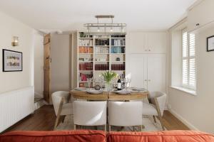 a dining room with a table and chairs at The Smithy in Chipping Norton