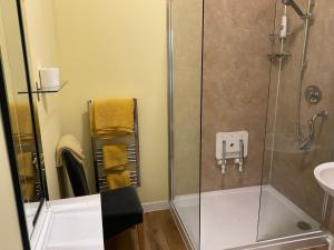 a bathroom with a shower and a sink at East Cliff Hotel in Dover +12 photos