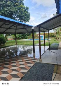 a pavilion with an umbrella on a patio at Villa RIVAR in Santa Helena