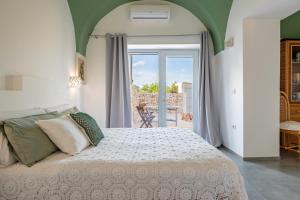 a bedroom with a bed and a door to a patio at La Casita Ostuni - Authentic Apulian Stay in Ostuni