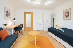 a bedroom with a bed and a desk and a table at Ressel Mansion in Bitterfeld