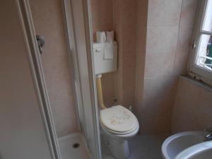 a small bathroom with a toilet and a sink at The Sunrise in Riomaggiore