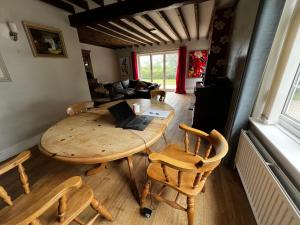 a room with a table and chairs with a laptop on it at Wellbet Farm in Lincoln