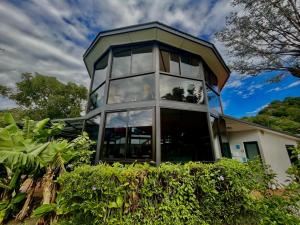 a house with glass windows on top of it at Hotel Isla Verde in Boquete