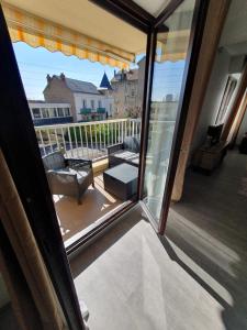 a view of a balcony from a sliding glass door at Le 28 C chouette - Spacieux - Box privé - Ascenseur - Centre in Dijon