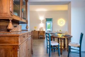 a kitchen with a table and chairs and a dining room at La Casita Ostuni - Authentic Apulian Stay in Ostuni