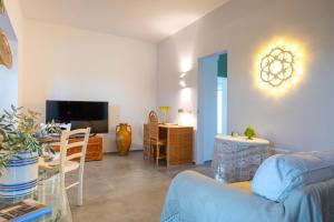 a living room with a couch and a table at La Casita Ostuni - Authentic Apulian Stay in Ostuni