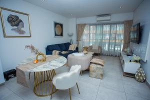 a living room with a couch and a table at The Steward Dwellings@Signature in Accra