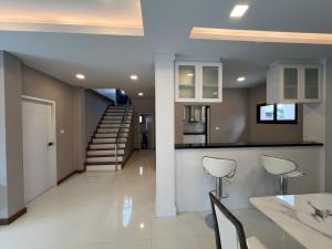 a kitchen and living room with a dining table and chairs at The Lake Huay Yai Three-Bedroom Villa in Ban Huai Yai +3 photos