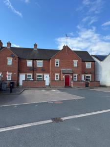 an empty parking lot in front of a brick building at Modern cosy sleeps 5 ground floor central MD in Market Drayton
