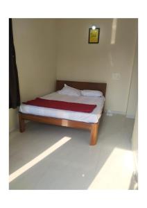 a bed in a small room with at YONA HomeStay in Alibag +13 photos