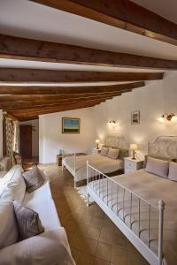 a large room with two beds and a couch at Can Busquets - Tramuntana Suite in Banyalbufar