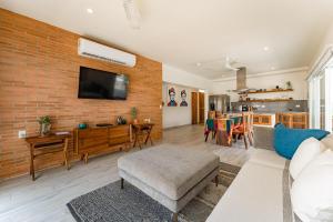 a living room with a brick wall at 3060 - Bocana Beach Condo B2 in Valerio Martínez
