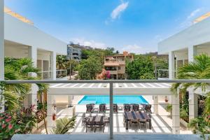 a view of a balcony with chairs and a swimming pool at 3060 - Bocana Beach Condo B2 in Valerio Martínez