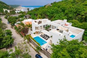 an aerial view of a white house with the ocean at 3060 - Bocana Beach Condo B2 in Valerio Martínez