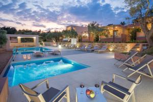a patio with a swimming pool and lounge chairs and a house at Aventura Village in Potos