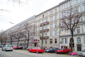 un grand bâtiment avec des voitures garées devant lui dans l'établissement Hotel Polo am ZOB, à Hambourg