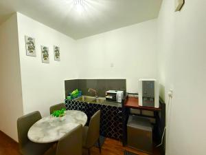 a small kitchen with a table and a sink at K avenue by TZ homestay in Donggongon