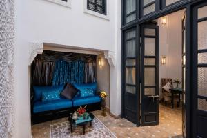 a living room with a blue couch and a table at Riad Star by Marrakech Riad in Marrakech