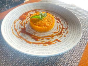 a white plate with a dessert on a table at Kareem Zanzibar in Zanzibar City