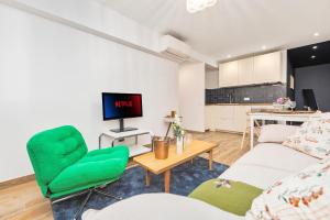 a living room with a couch and a table at 2mn Monaco - Coquet appartement rénové - DM in Roquebrune-Cap-Martin