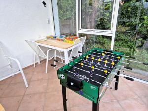 a ping pong table sitting on a patio at Sonnenschein 0L mit Terrasse und Garten in Friedrichshafen