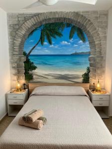 a bedroom with a bed with a view of the ocean at FARO PLAYA in Cullera