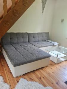 a couch in a living room with a glass table at Villa Dany in Klagenfurt