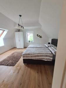 a bedroom with a large bed and a wooden floor at Villa Dany in Klagenfurt