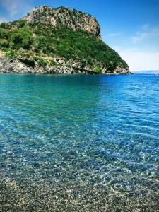 a small island in the middle of a body of water at Zia Manuccia in Praia a Mare +6 photos