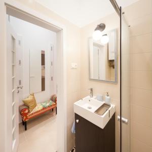 a bathroom with a sink and a mirror at STUDIO 16 in Sopron