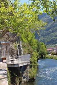 a bridge over a river next to a mountain at Hôtel Confort 09 ou HC-09 in Tarascon-sur-Ariège